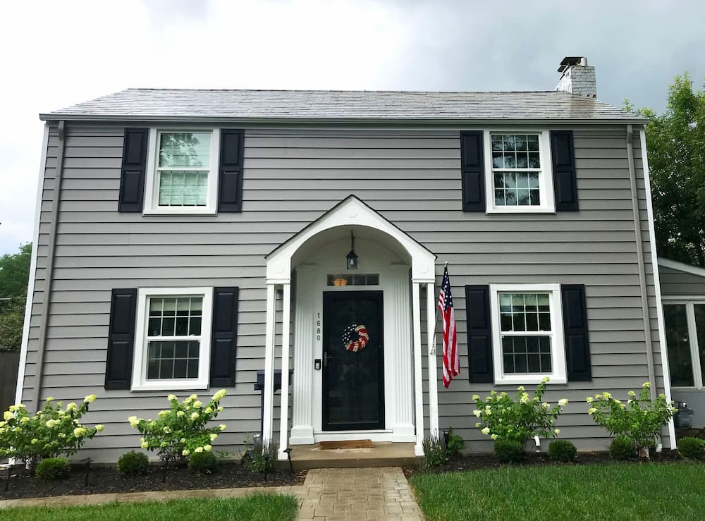 Exterior view of gray home with all-new white vinyl single-hung windows 