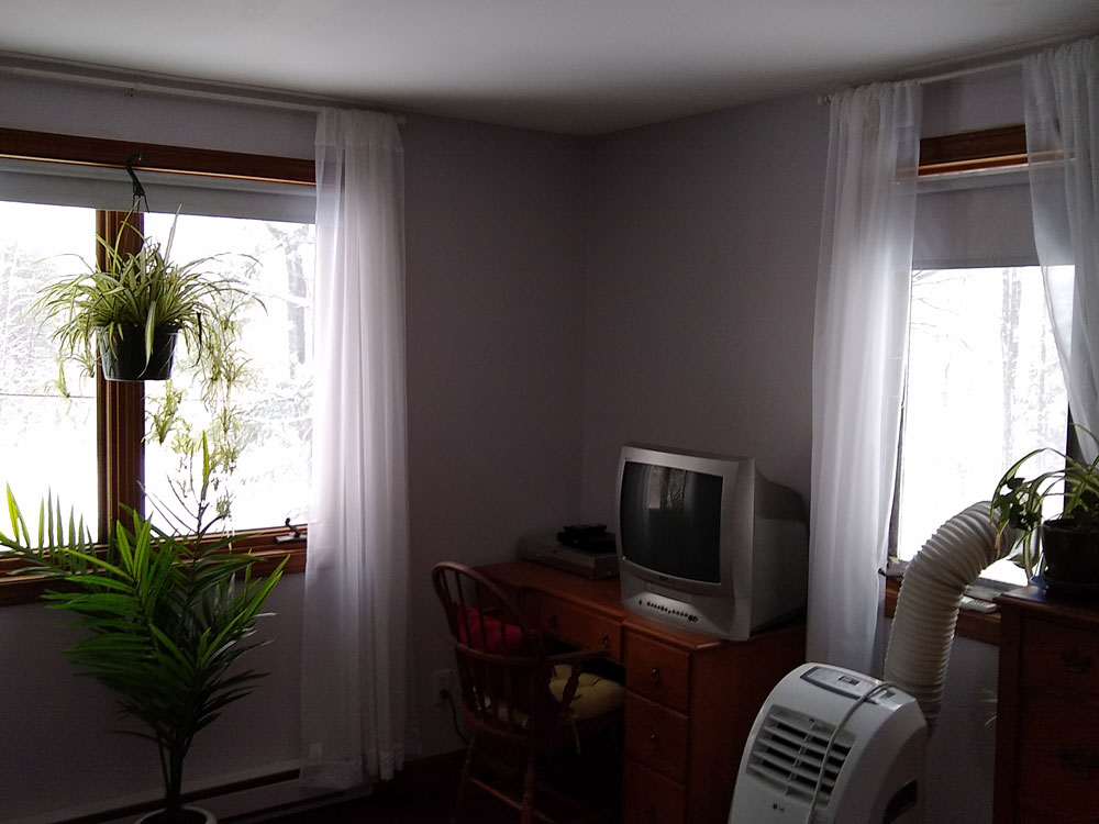 Bedroom of home in Northfield, MA, before window replacement