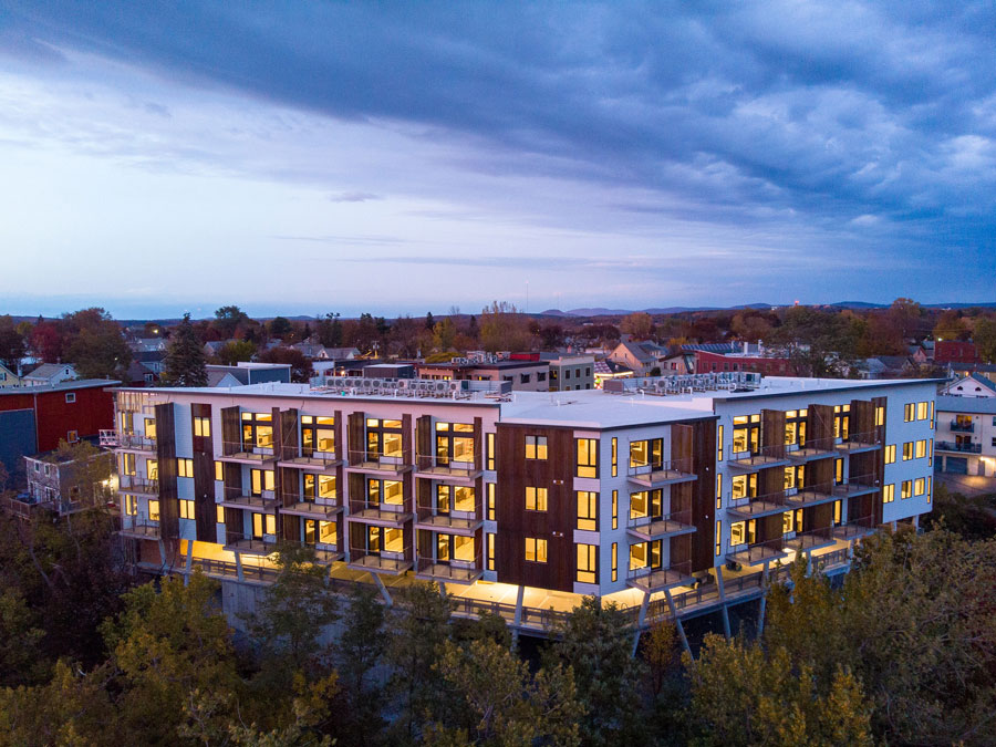 One Lakeview Apartments in Burlington, Vermont, with new windows lit up at dusk
