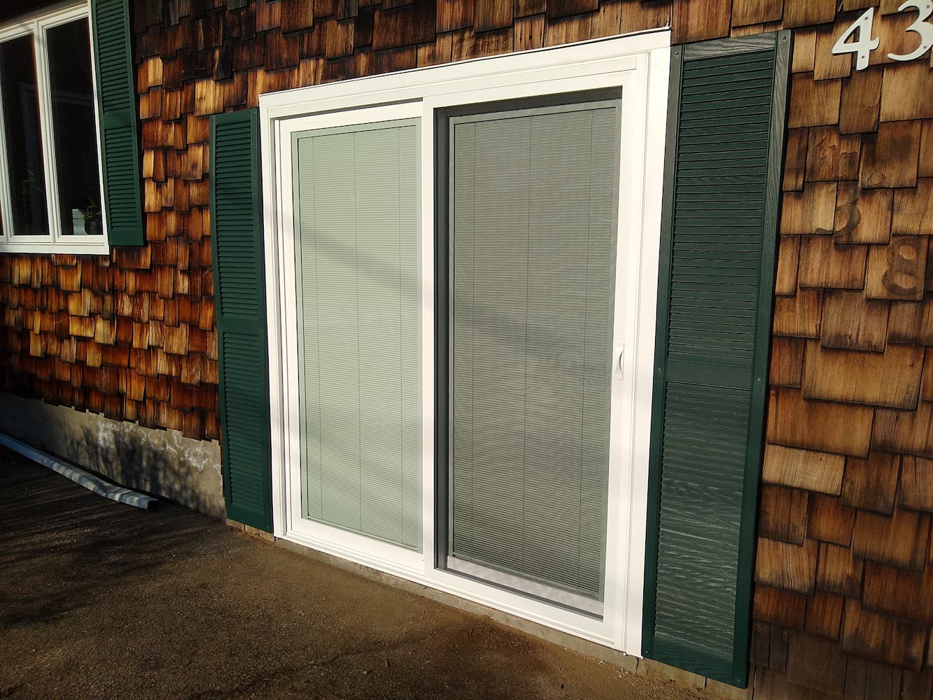 After exterior photo of newly installed Pella sliding patio door