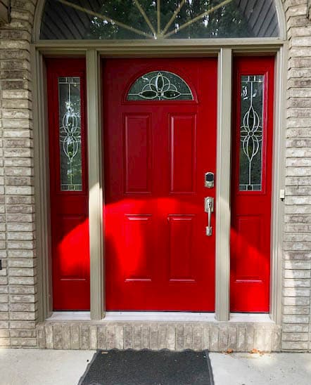 Red fiberglass entry door system with decorative glass