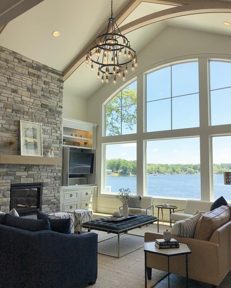 Interior view of fixed and casement wood windows overlooking a lake