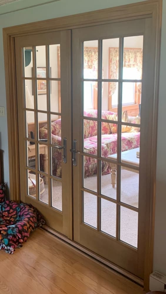 Interior view of wooden double French doors with traditional grille pattern