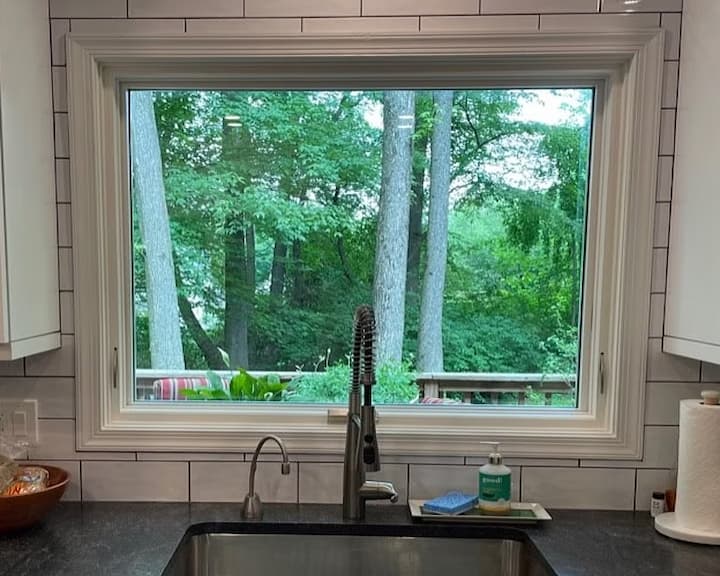 White awning window behind kitchen sink