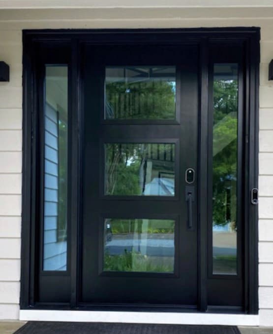 Exterior of modern black fiberglass entry door with dual sidelights