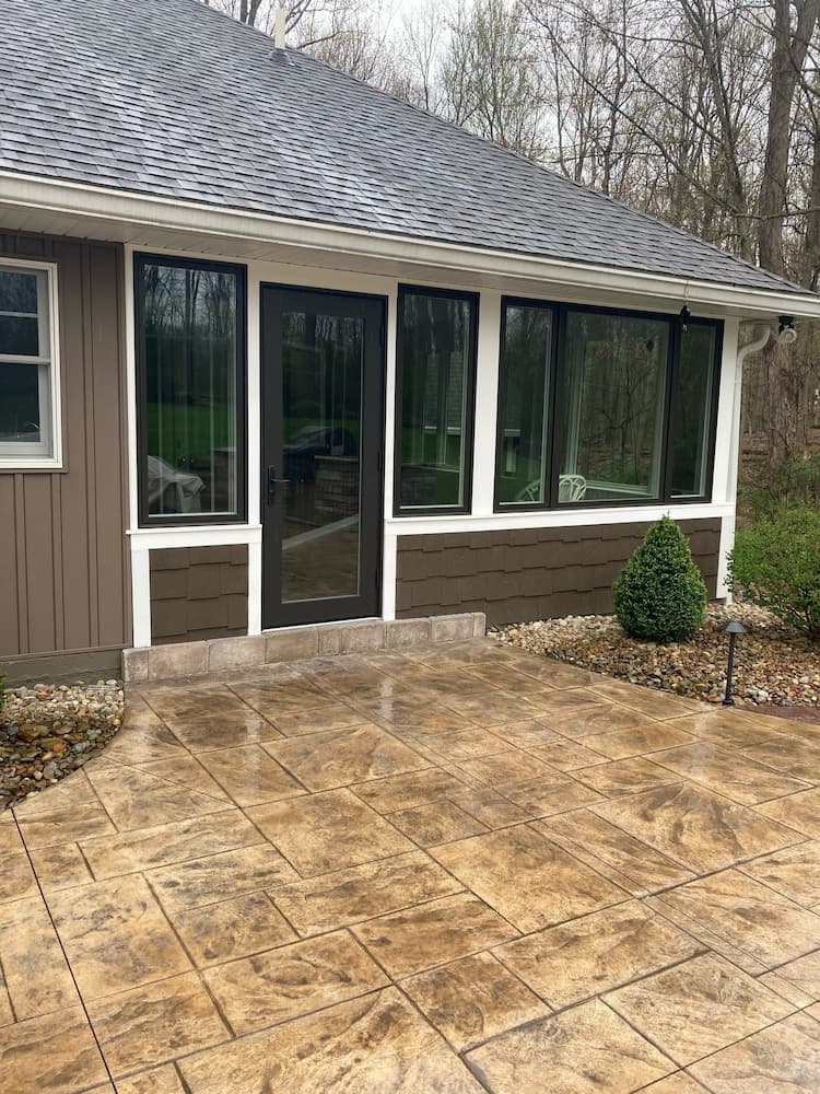 Cleveland home featuring rows of black casement windows and a new glass patio door