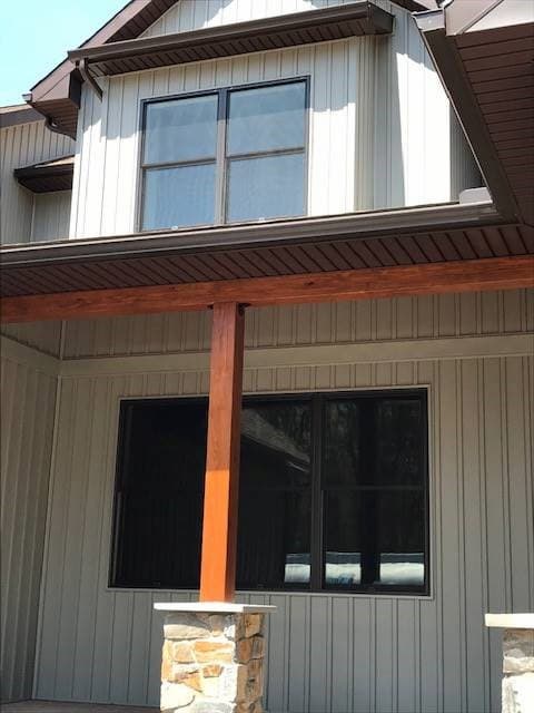 Exterior view of black double-hung windows on the first and second floor of a home