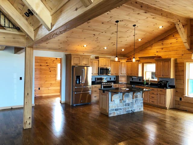 Alternate interior view of log cabin kitchen with new wood windows