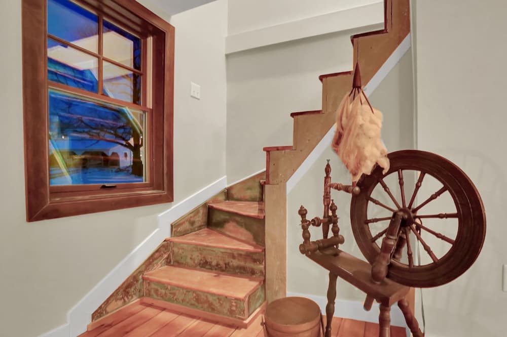 Interior view of a stairwell and wood double-hung window