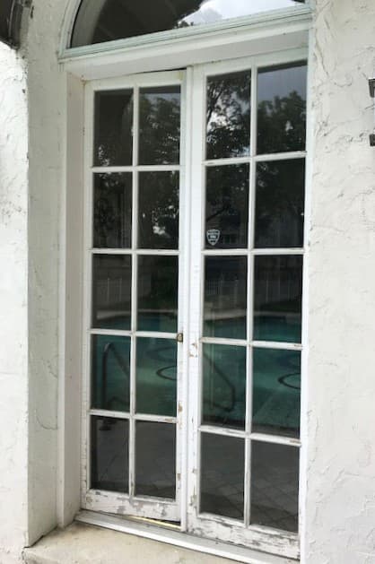 Exterior view of old white French door