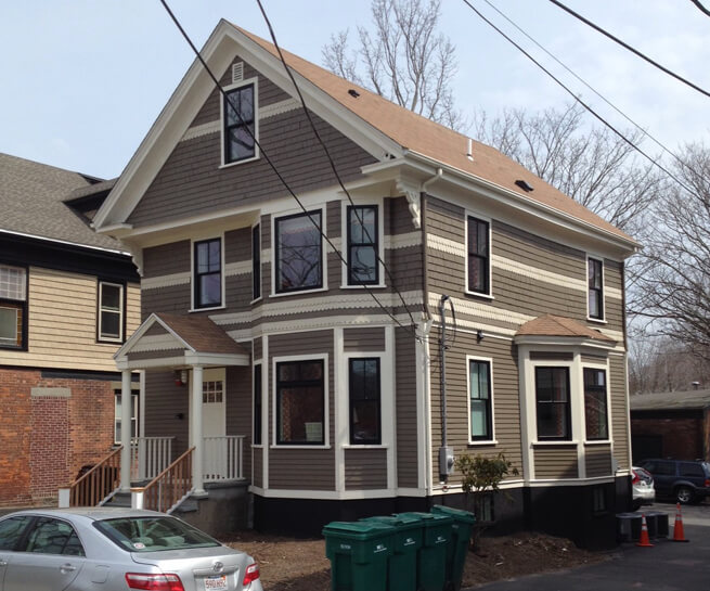 Black double-hung and bay windows on the back of The Attwater in Newport, RI