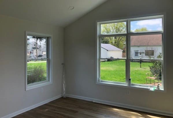 Interior view of room with new white wood double-hung windows