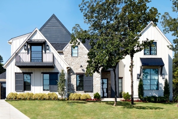 White home with dark, decorative exterior window trim