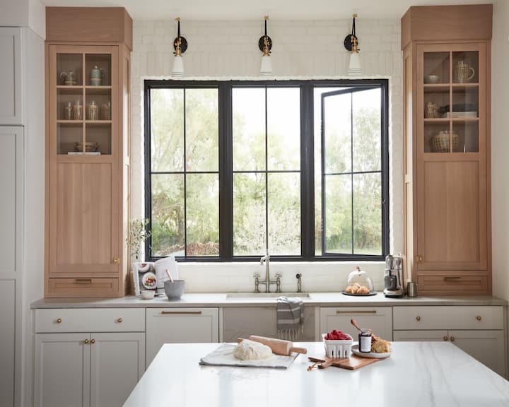 Black fiberglass casement windows above the sink in a modern kitchen.