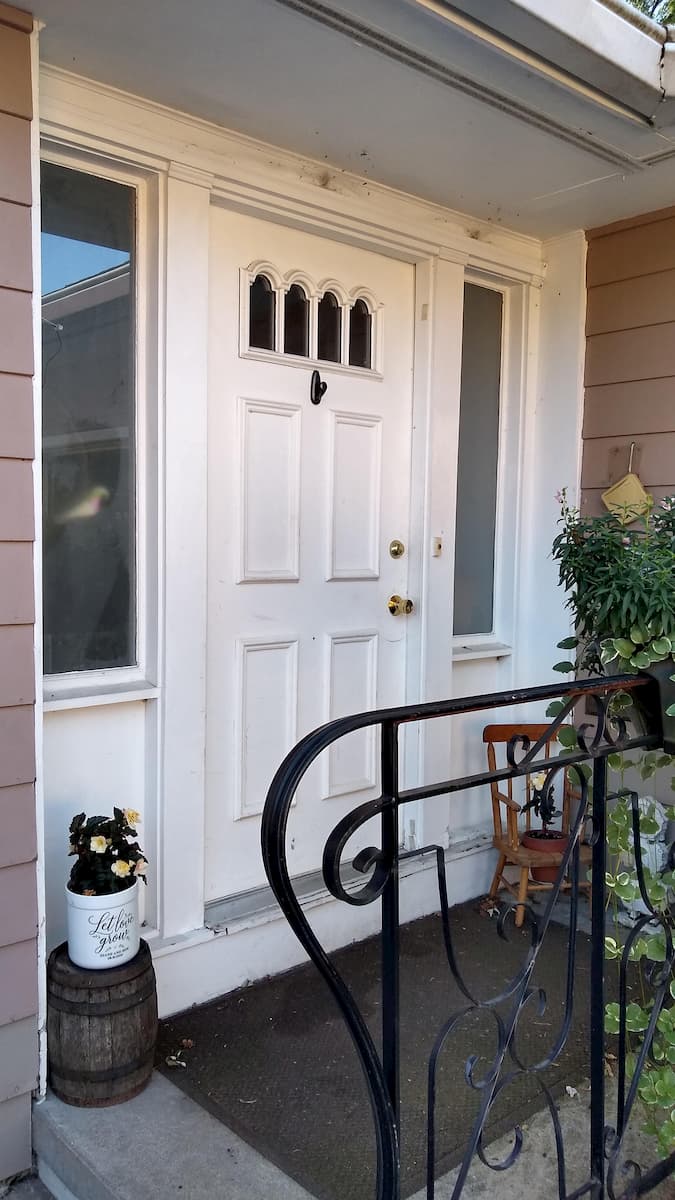 Old white entry door system with two sidelights
