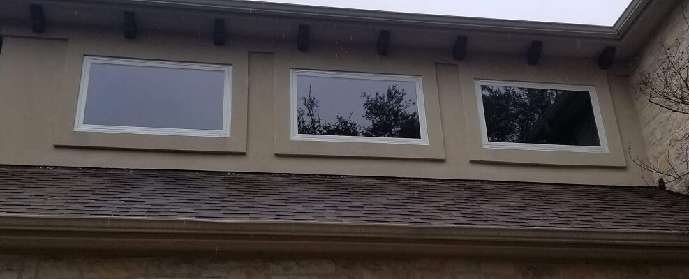 side of austin home with new fiberglass casement, single hung and sliding windows
