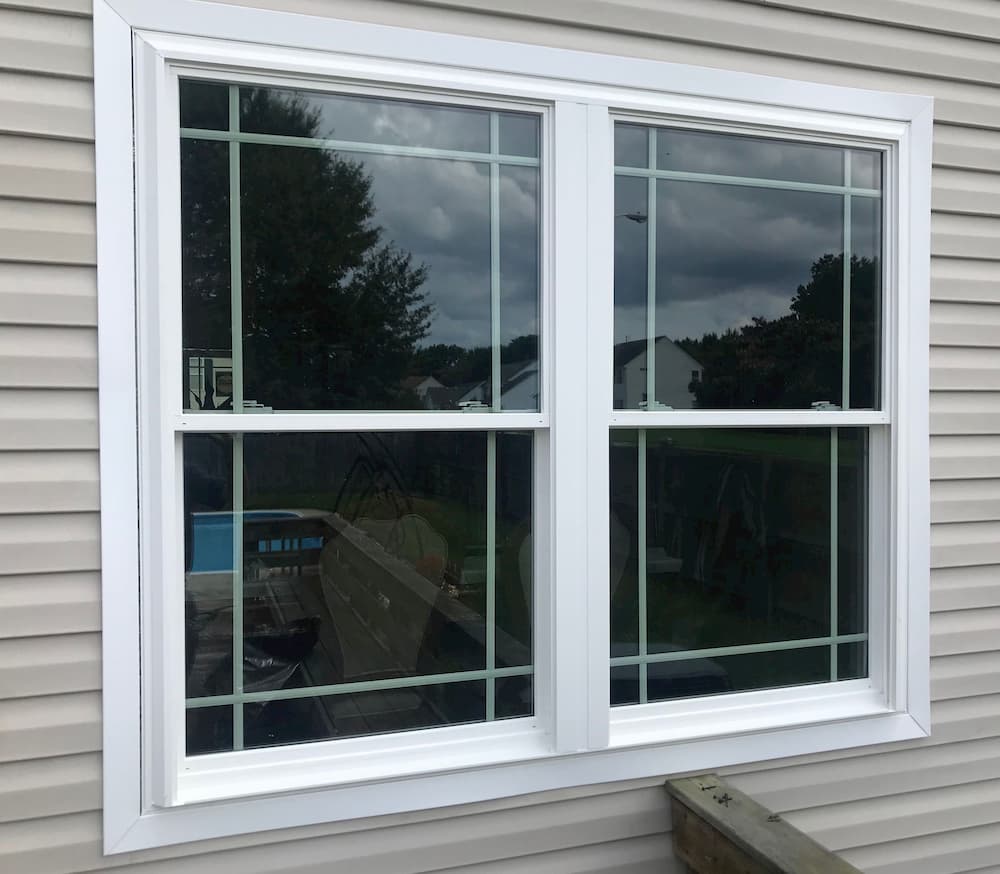 New fiberglass double-hung windows with prairie grille pattern