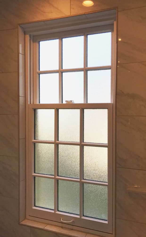 Interior view of new wood double-hung window in a bathroom