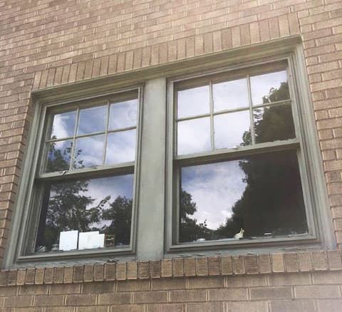 Old double-hung windows on a brick home