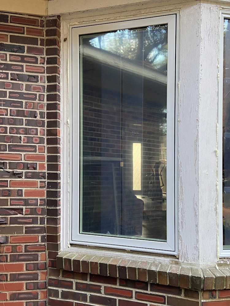 Brick home in Norfolk with new white wood casement window