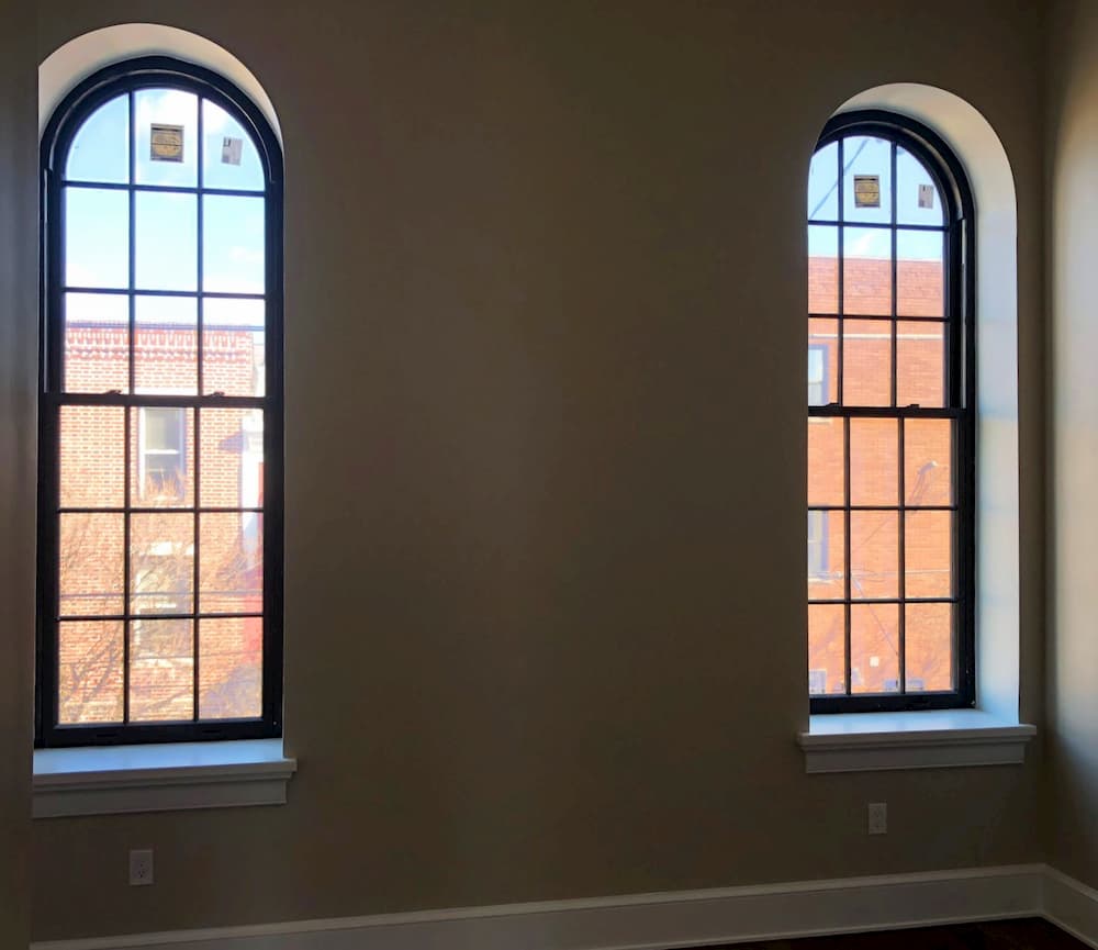 Interior view of two new wood arch-top single-hung windows