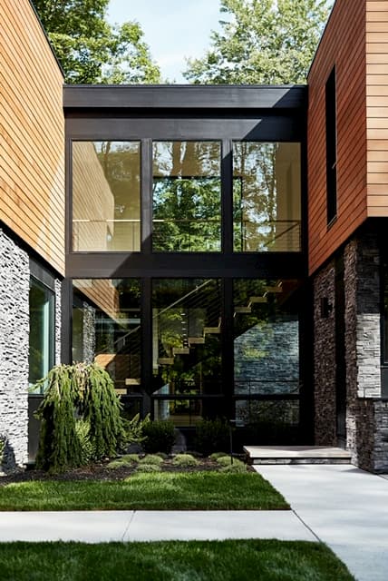 Front entry with contemporary wood windows 