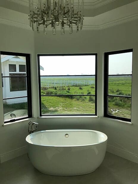 Bathroom with wood casement and fixed windows with contemporary grille pattern and black finish