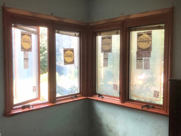 Interior view of four new wood casement windows in the corner of a room