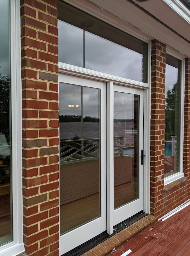 New fiberglass patio doors and windows on a red brick home