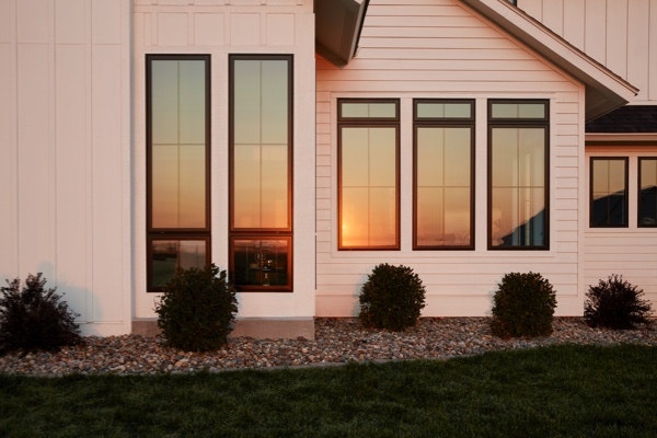 beautiful modern farmhouse exterior in sunset lighting featuring Pella windows
