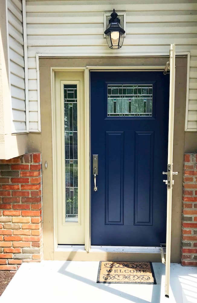 New blue fiberglass entry door with statement glass sidelight