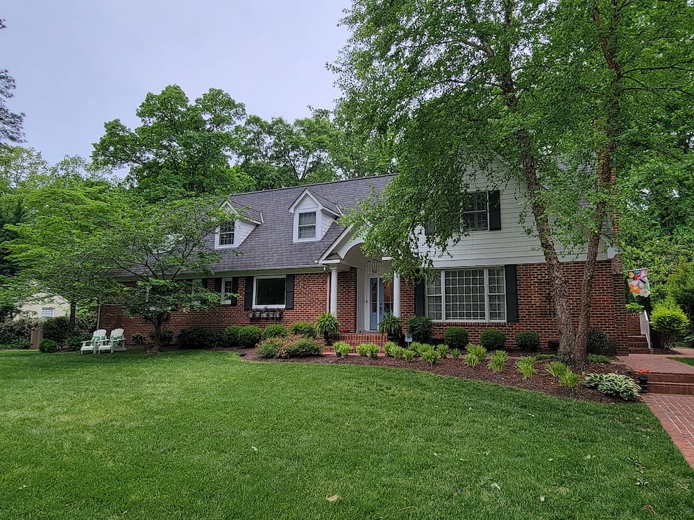 Red brick exterior of Henrico home with white windows