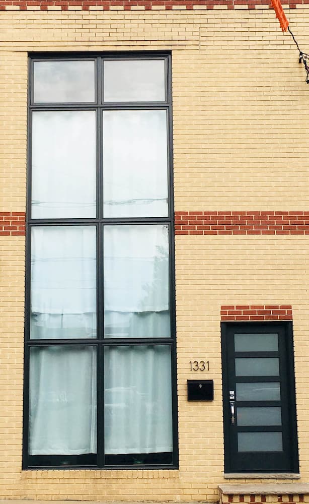 black contemporary windows on brick home