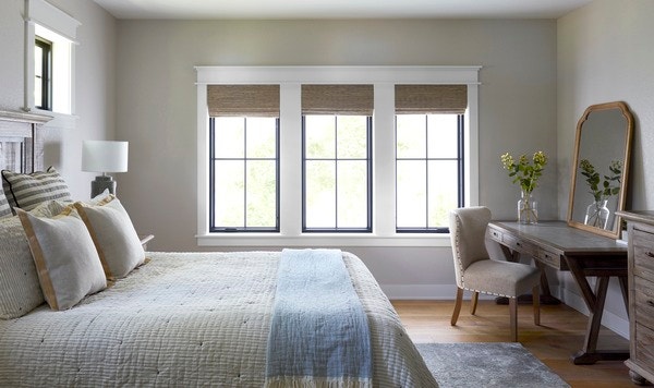 Pella windows with window treatment in bedroom featuring mirror