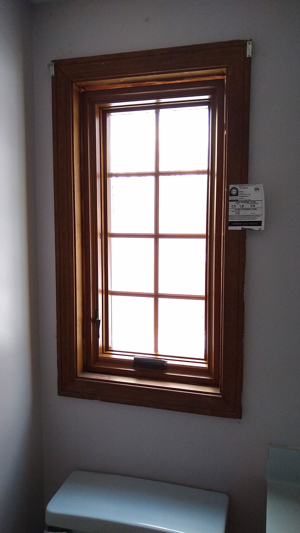 New double-hung window with grilles in bathroom of Northfield, MA, home