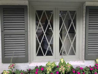 Old casement windows with gray shutters