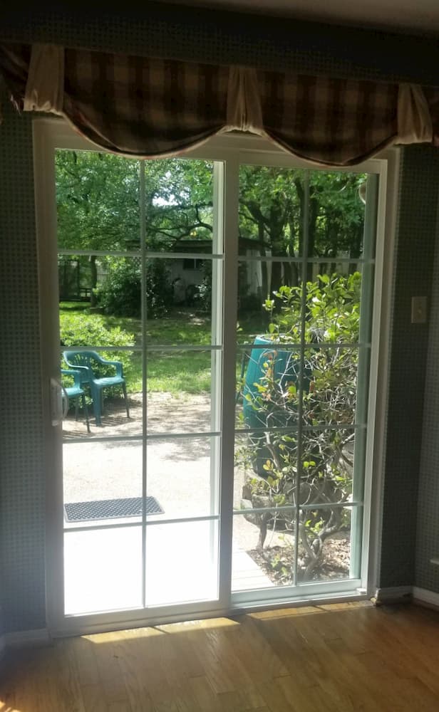 Interior view of white vinyl sliding patio door with traditional grille pattern