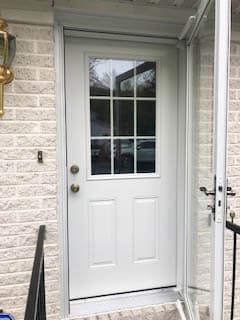 New white fiberglass entry door with traditional grille pattern