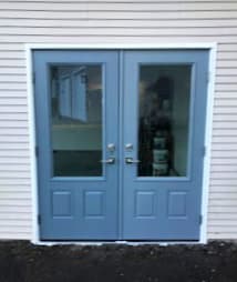 Exterior view of new blue fiberglass double entry doors