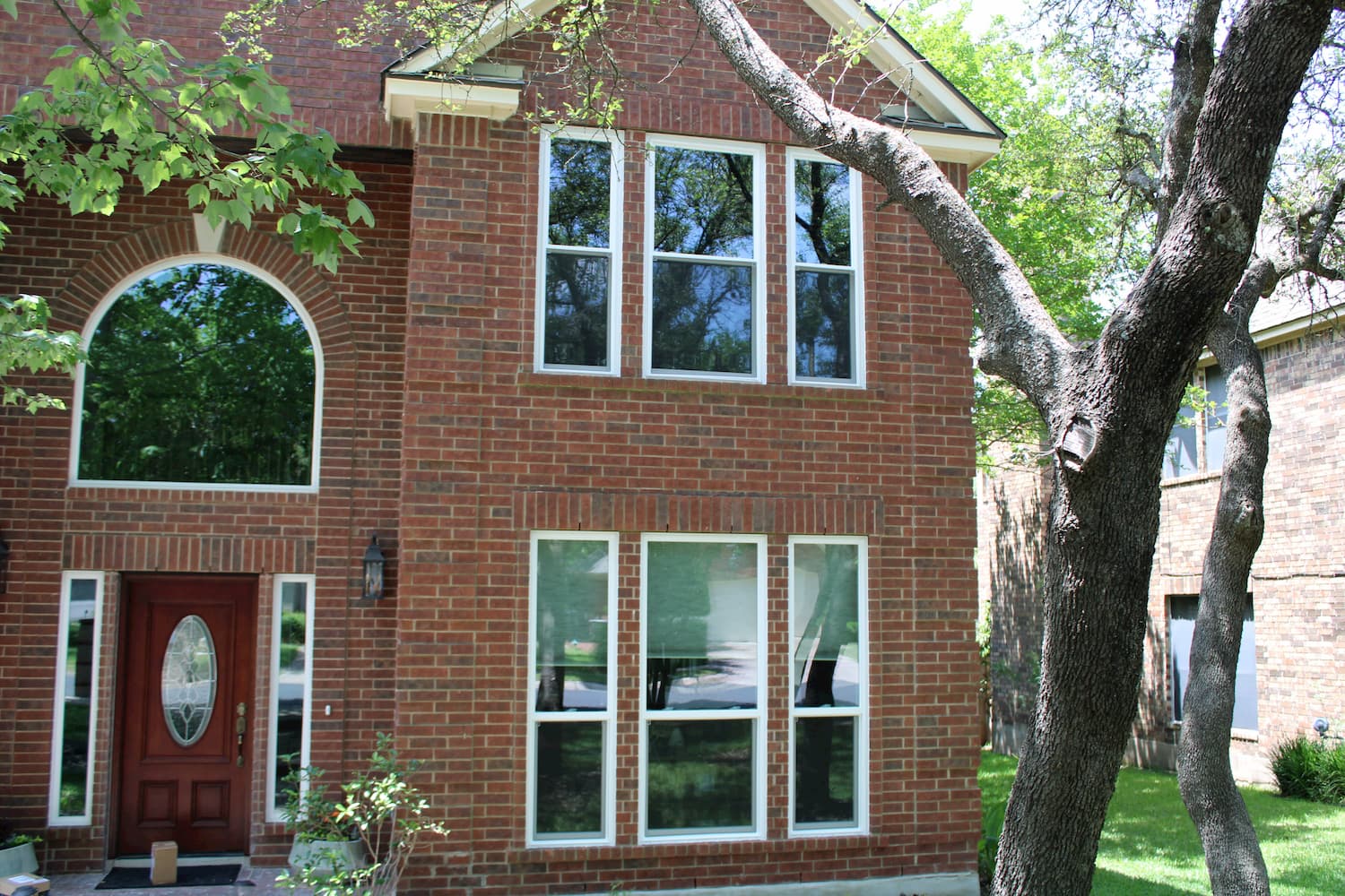 exterior shot of brick cedar park home with replacement pella 250 series windows