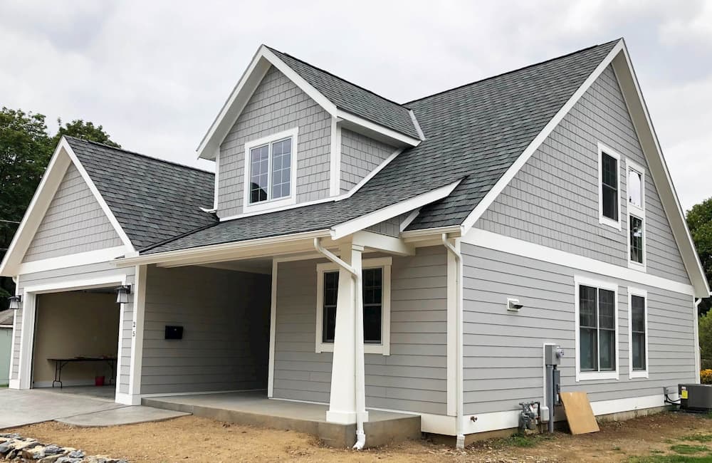 Exterior of new gray two-story home with Pella wood windows