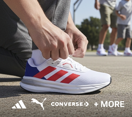 Person tying laces on a white Adidas athletic shoe with red stripes and blue heel accents. Adidas, PUMA, and Converse logos are shown on the bottom half of the image.
