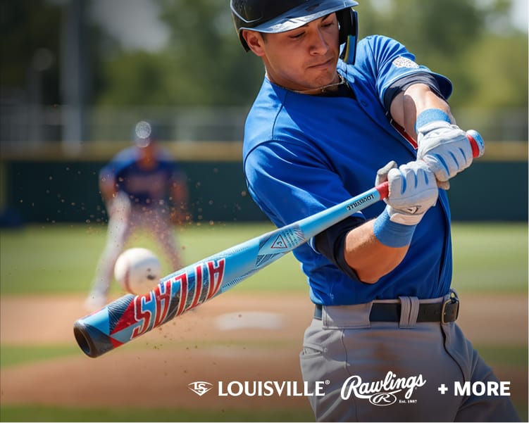 Baseball player swinging a Louisville Slugger bat during a game with an out-of-focus baseball field in the background.