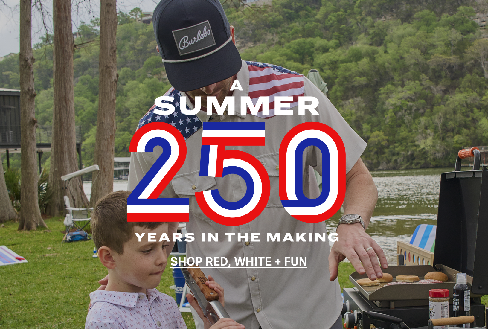 A Summer 250 Years in the Making. A dad and his son grill burgers and hot dogs at a lakeside Fourth of July cookout. Shop red, white and fun.