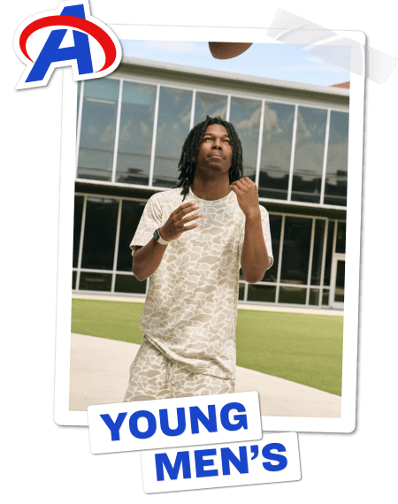 Young men’s back-to-school category banner featuring young men playing football outdoors and walking in a school hallway while wearing branded sets.