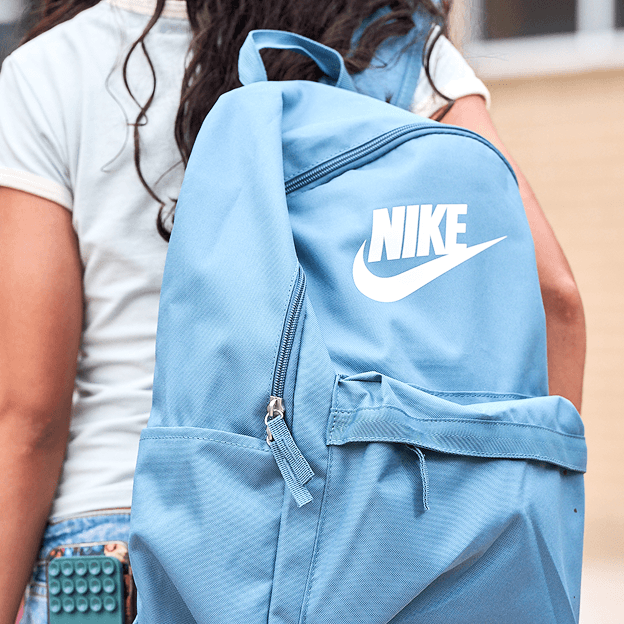 Light blue Nike backpack with front pocket and logo.