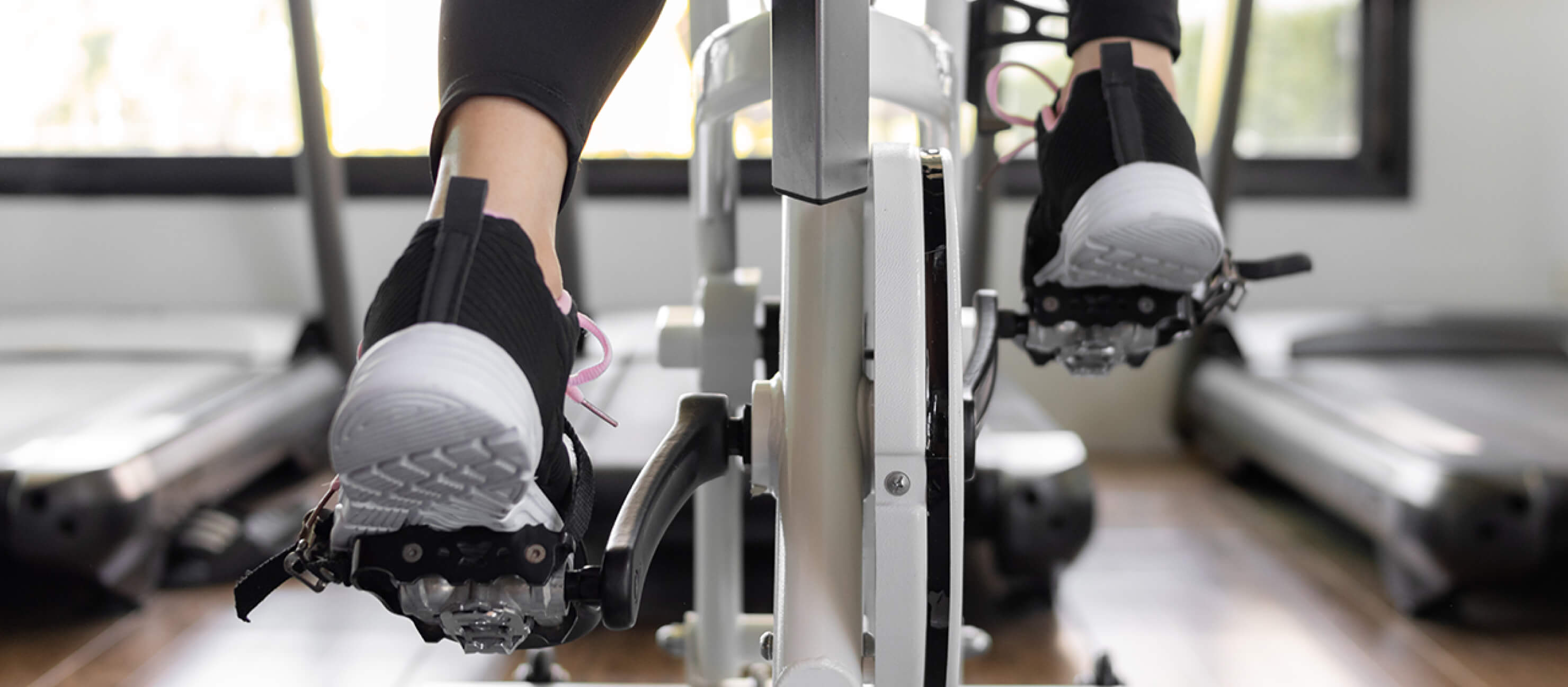 Woman on a stationary bike works out in a gym