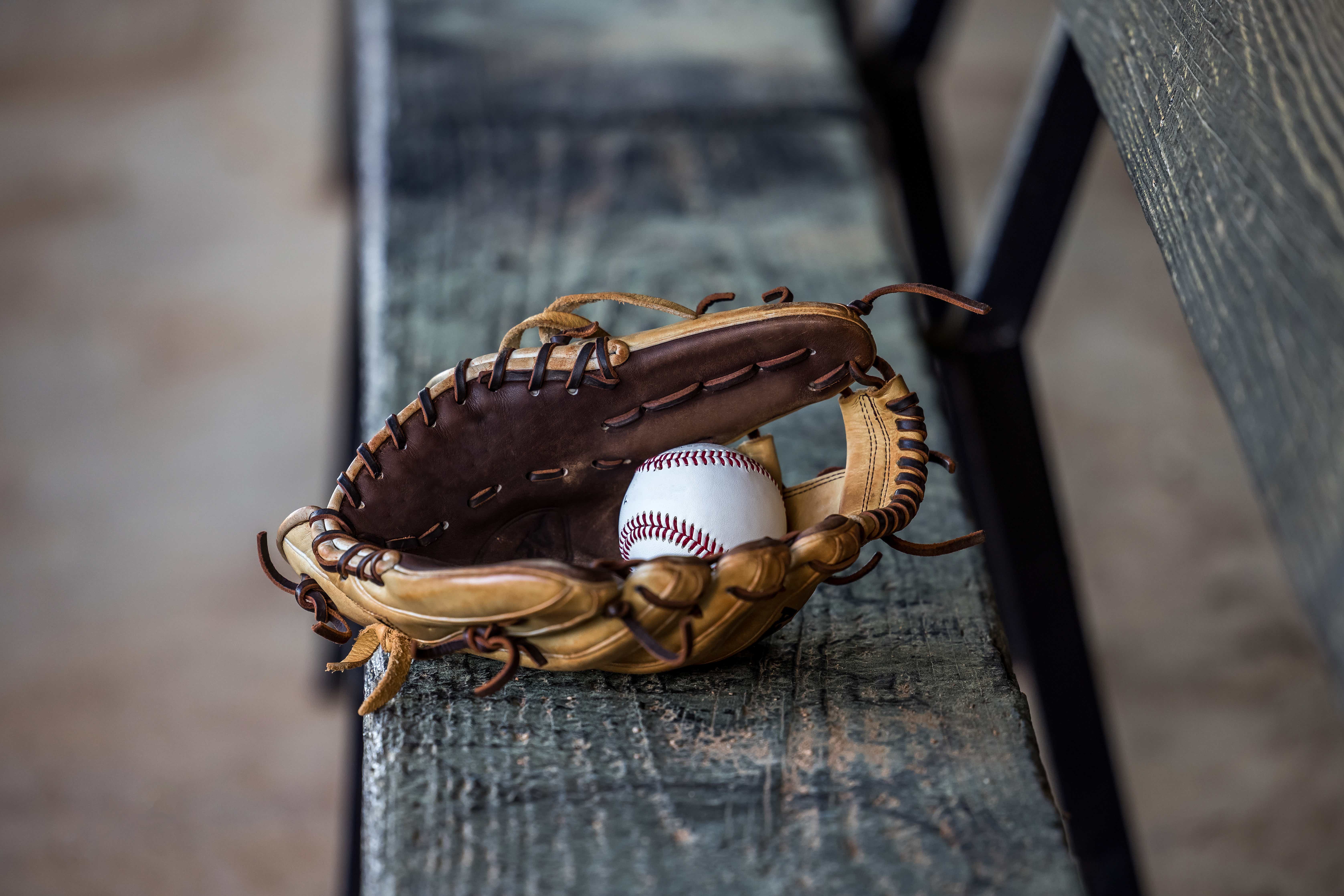 Baseball glove on a dugout bench