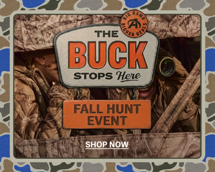 Hunting-themed promotional sign reading The Buck Stops Here and Fall Hunt Event displayed with camouflage accents and outdoor gear imagery.