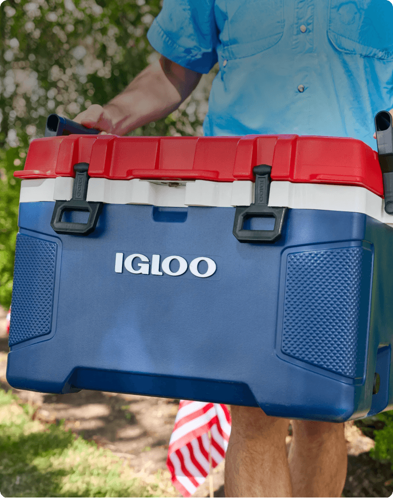 Blue and red Igloo cooler being carried outdoors highlighting party essentials for summer gatherings.